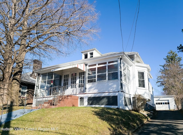 40 Fairview Ave, Hudson, NY 12534 - view of front facade featuring a front lawn, an outdoor structure, a chimney, a garage, and asphalt driveway