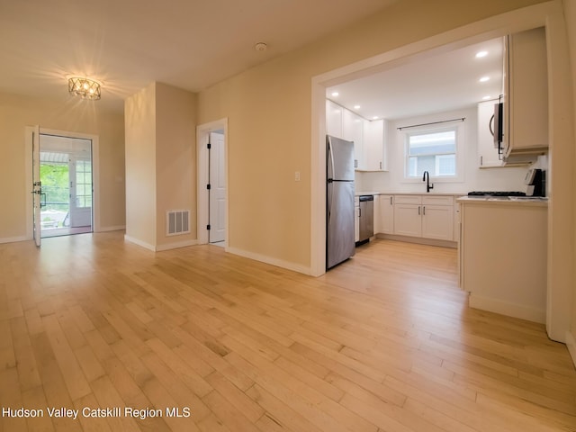 40 Fairview Ave, Hudson, NY 12534 - kitchen featuring appliances with stainless steel finishes, light wood-style floors, white cabinetry, plenty of natural light, and recessed lighting