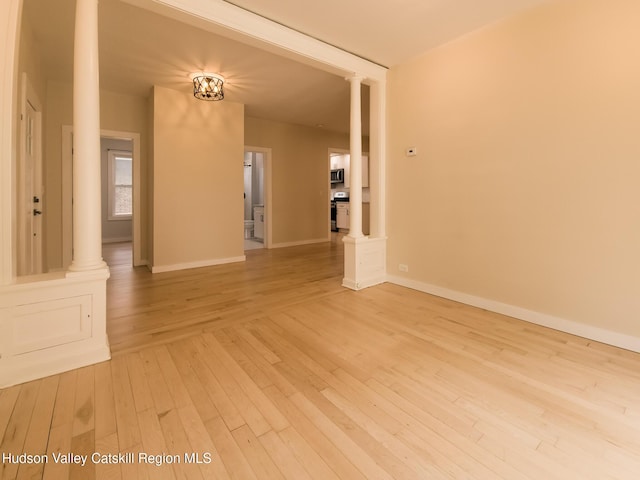 40 Fairview Ave, Hudson, NY 12534 - spare room with decorative columns and light wood-style flooring