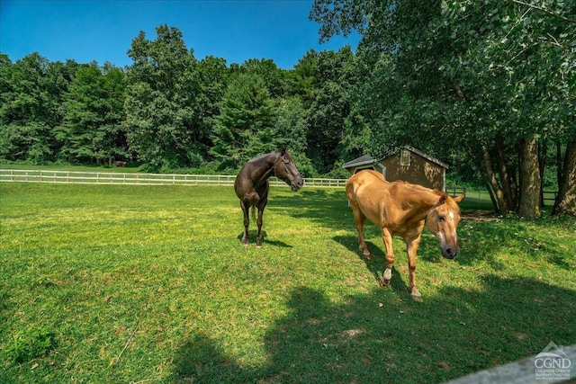  - view of community featuring an exterior structure, an outbuilding, and fence