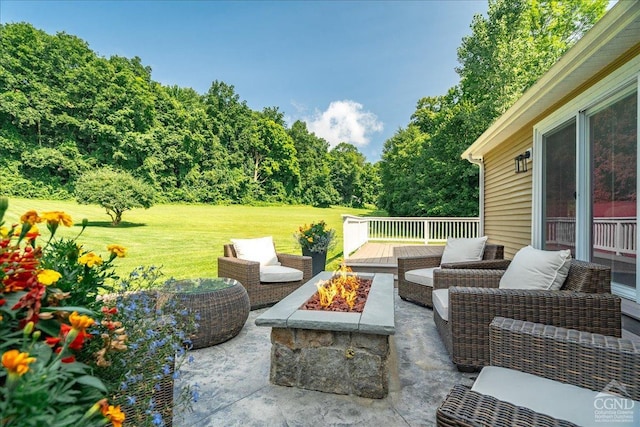 - view of patio featuring an outdoor fire pit
