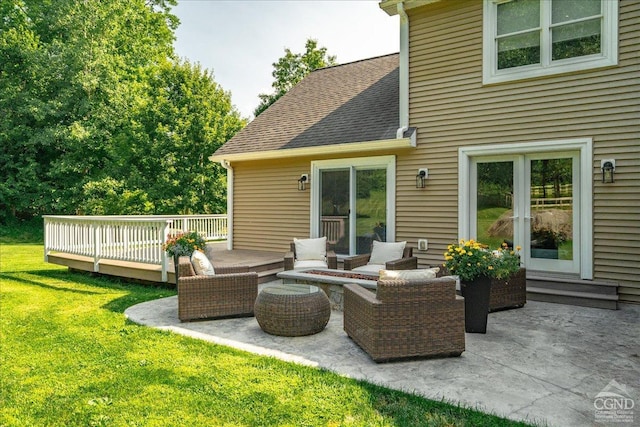  - rear view of property featuring a lawn, a deck, a shingled roof, and a patio area