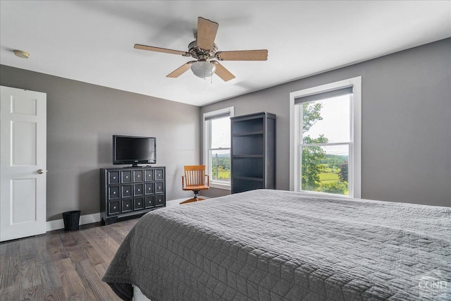  - bedroom with dark wood-style floors, ceiling fan, and baseboards