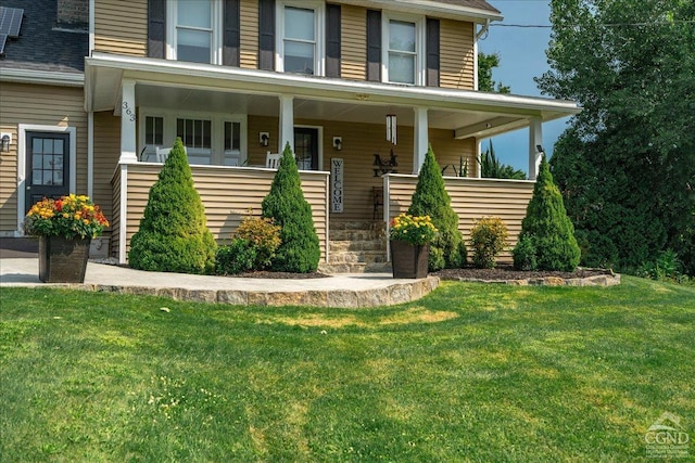  - view of front of home with a front yard and a porch