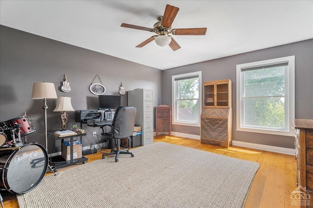  - office space with a ceiling fan, baseboards, and wood finished floors