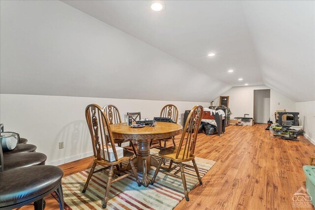  - dining room featuring vaulted ceiling, light wood-style floors, recessed lighting, and baseboards