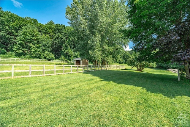  - view of yard with an outbuilding, a storage shed, and a rural view