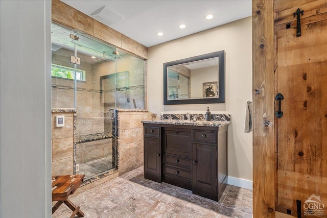  - bathroom with a stall shower, vanity, marble look tiles, recessed lighting, and baseboards