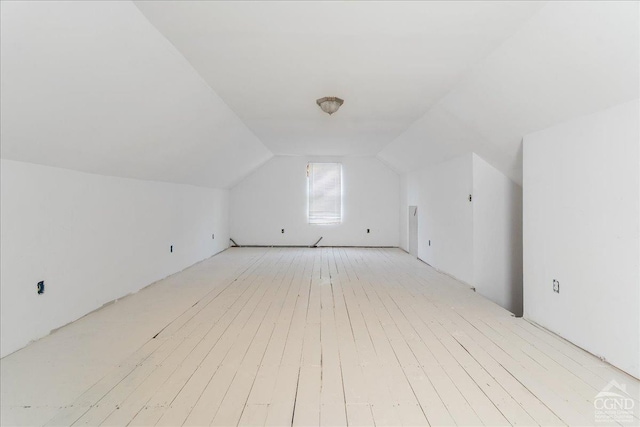  - additional living space with light wood-style floors and lofted ceiling