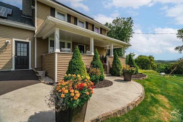  - view of front of house with a front lawn and covered porch