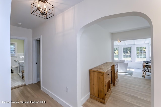 179 Grove St, Tillson, NY 12486 - hall with arched walkways and light wood finished floors