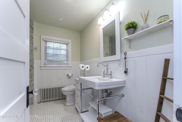 179 Grove St, Tillson, NY 12486 - bathroom featuring radiator heating unit, wainscoting, toilet, tile patterned floors, and a sink