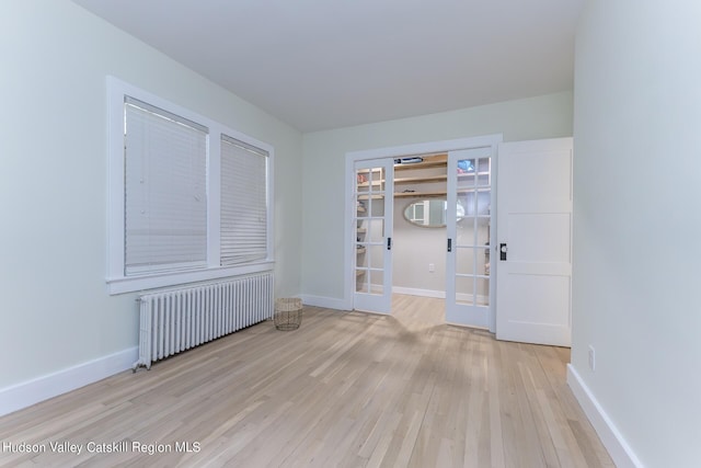 179 Grove St, Tillson, NY 12486 - spare room with radiator, baseboards, french doors, and light wood-style floors