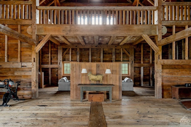 118 Finkle Rd, Ancram, NY 12503 - unfurnished living room featuring wood-type flooring, healthy amount of natural light, and wood walls