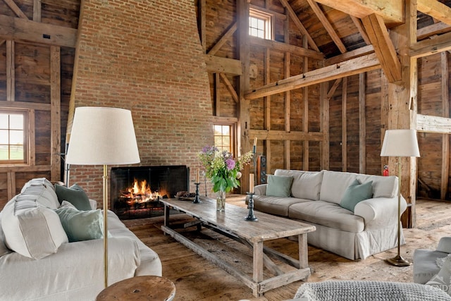 118 Finkle Rd, Ancram, NY 12503 - living area with high vaulted ceiling, plenty of natural light, a brick fireplace, wood ceiling, and wood finished floors