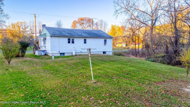 rear view of property with a yard