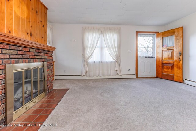 unfurnished living room with dark carpet, baseboard heating, and a fireplace