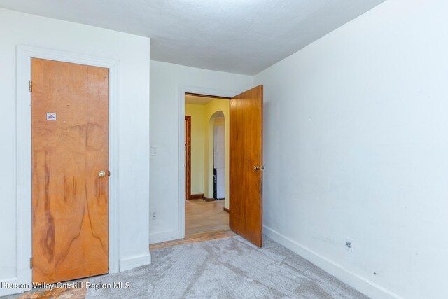 unfurnished bedroom with light colored carpet