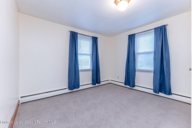 spare room featuring light colored carpet