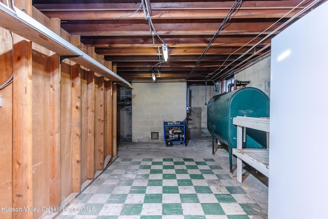 unfinished basement with heating fuel and tile patterned floors