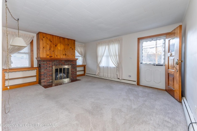 unfurnished living room featuring a healthy amount of sunlight and a baseboard radiator