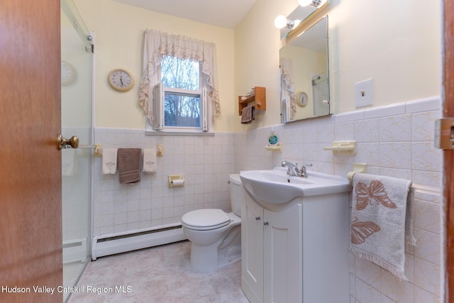 bathroom featuring baseboard heating, vanity, tile walls, and toilet