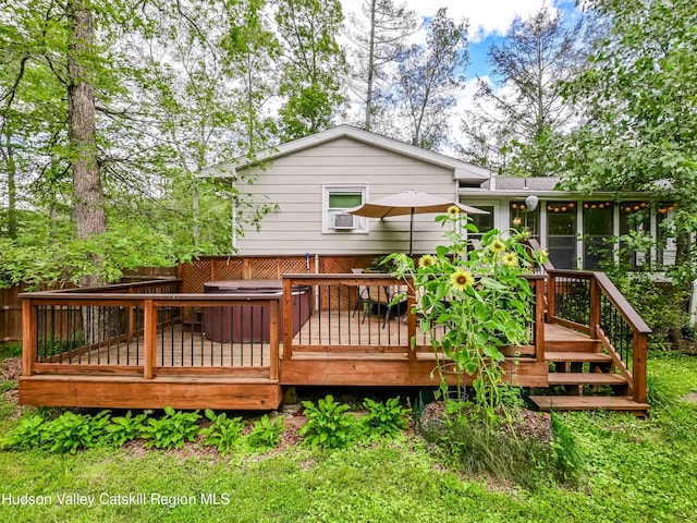 deck with a sunroom and a jacuzzi