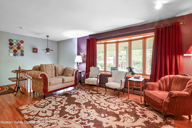 living room with hardwood / wood-style floors and ceiling fan