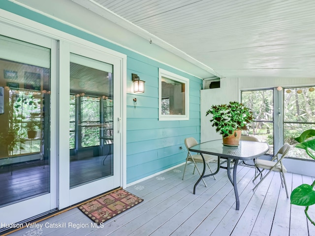 sunroom / solarium featuring lofted ceiling