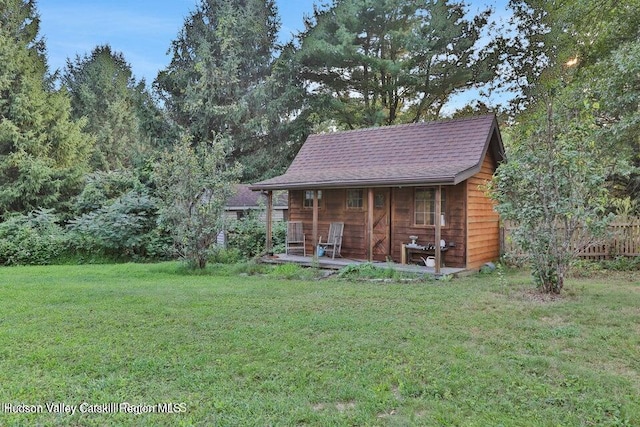 view of outbuilding featuring a lawn