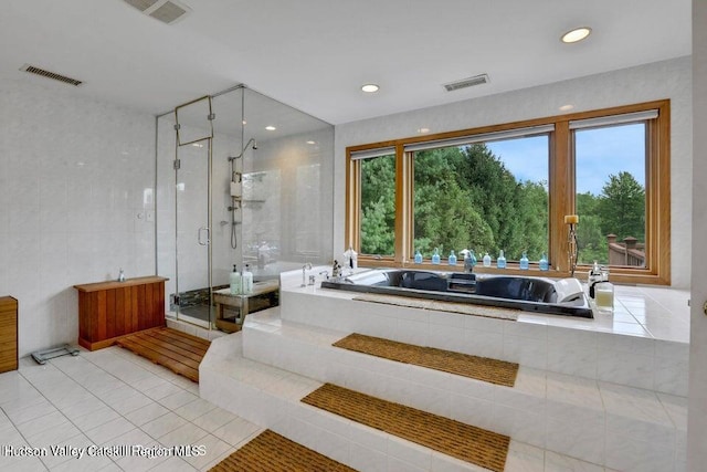 bathroom with tile patterned flooring and independent shower and bath