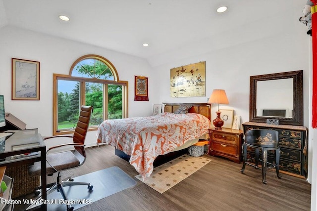 bedroom featuring dark wood-type flooring and vaulted ceiling