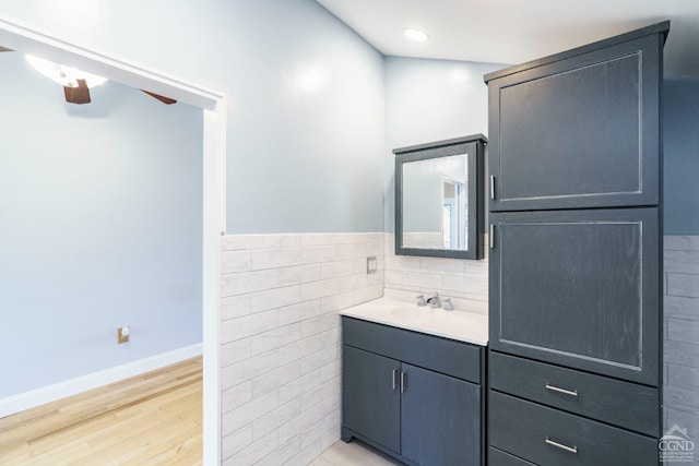 38 Cheviot Rd Unit 8, Germantown, NY 12526 - bathroom with wood finished floors, a ceiling fan, vanity, tile walls, and baseboards