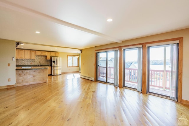 38 Cheviot Rd Unit 8, Germantown, NY 12526 - unfurnished living room featuring a baseboard radiator, light wood finished floors, beamed ceiling, baseboards, and a sink