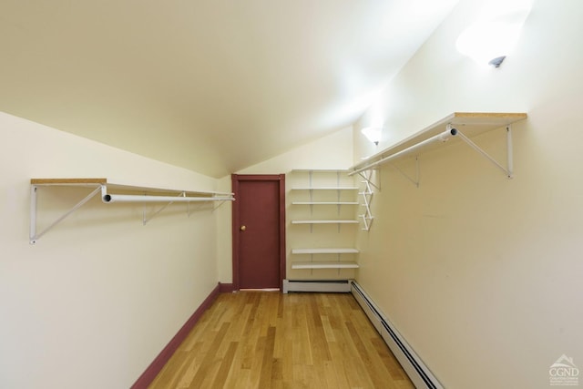 38 Cheviot Rd Unit 8, Germantown, NY 12526 - walk in closet featuring a baseboard heating unit, light wood finished floors, and lofted ceiling