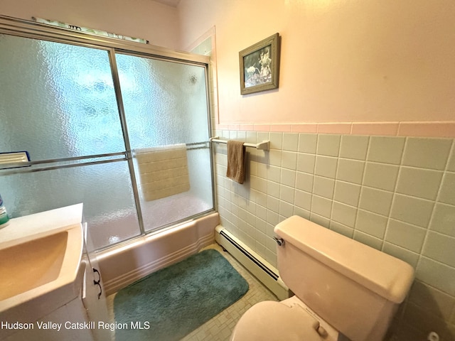 258 Watson Hollow Rd, West Shokan, NY 12494 - bathroom featuring a baseboard heating unit, tile walls, toilet, enclosed tub / shower combo, and vanity