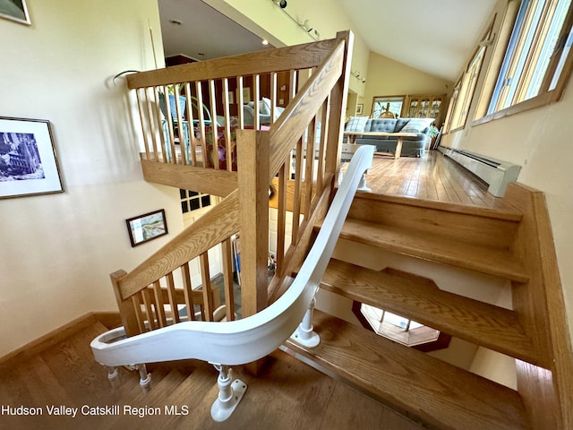 258 Watson Hollow Rd, West Shokan, NY 12494 - staircase with hardwood / wood-style floors, a baseboard heating unit, vaulted ceiling, and baseboards