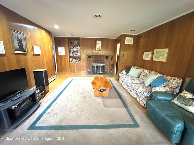 258 Watson Hollow Rd, West Shokan, NY 12494 - living area featuring wood walls, baseboard heating, wood finished floors, a fireplace, and ornamental molding