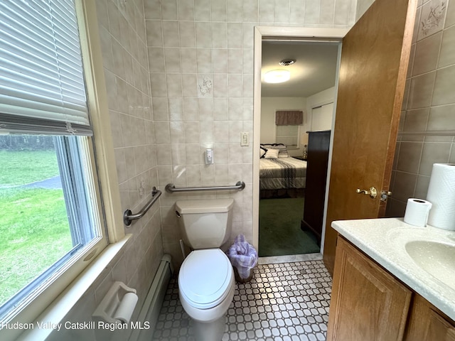 258 Watson Hollow Rd, West Shokan, NY 12494 - ensuite bathroom with tile walls, toilet, vanity, and a baseboard radiator