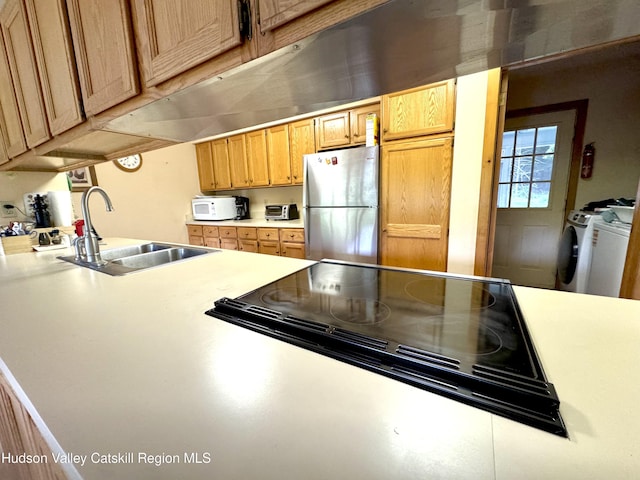 258 Watson Hollow Rd, West Shokan, NY 12494 - kitchen with freestanding refrigerator, washer and clothes dryer, white microwave, a sink, and light countertops