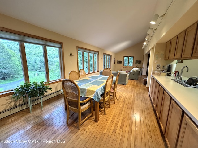 258 Watson Hollow Rd, West Shokan, NY 12494 - dining space featuring light wood-type flooring, vaulted ceiling, and a baseboard radiator