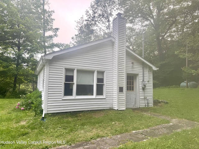 258 Watson Hollow Rd, West Shokan, NY 12494 - property exterior at dusk with a chimney and a lawn