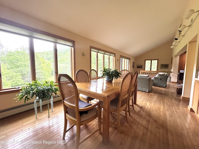 258 Watson Hollow Rd, West Shokan, NY 12494 - dining space featuring hardwood / wood-style flooring, lofted ceiling, and a baseboard heating unit