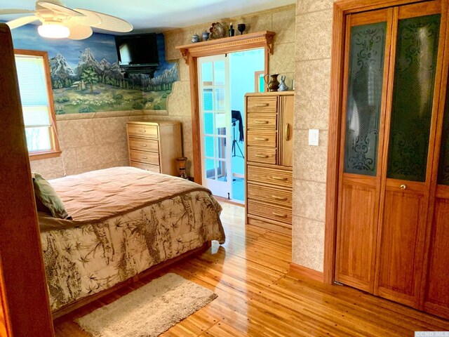 160 Willowbrook Rd, Hudson, NY 12534 - bedroom featuring light wood-style flooring, tile walls, wallpapered walls, and wainscoting