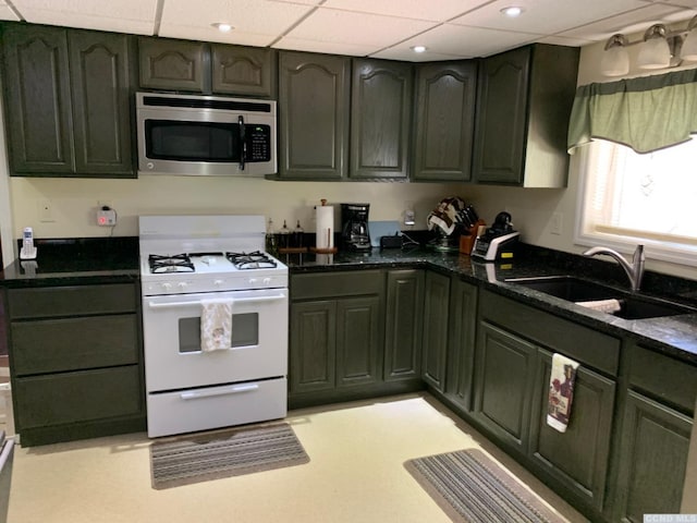 160 Willowbrook Rd, Hudson, NY 12534 - kitchen with stainless steel microwave, white gas range, a sink, green cabinets, and a paneled ceiling