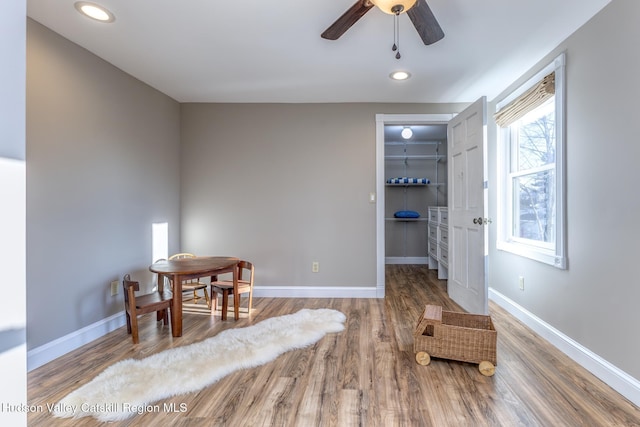 living area featuring hardwood / wood-style flooring and ceiling fan