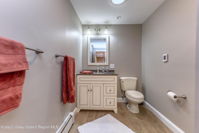 bathroom featuring hardwood / wood-style flooring, vanity, and toilet