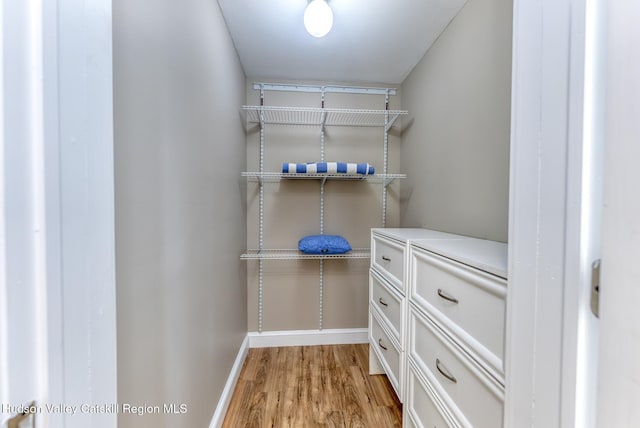 spacious closet with light hardwood / wood-style floors