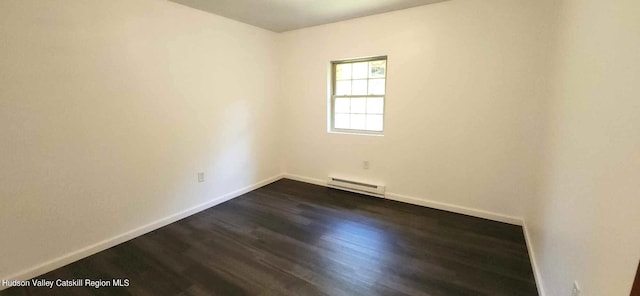 unfurnished room featuring baseboard heating and dark hardwood / wood-style flooring