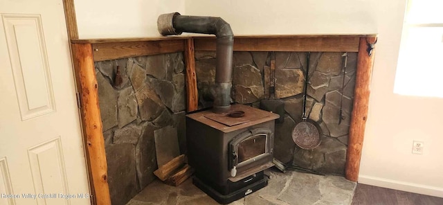 interior details featuring hardwood / wood-style flooring and a wood stove